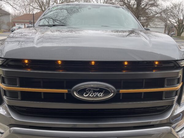 Front view of a ford car with some yellow lights